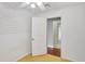 Spare bedroom with open door to hallway, wood floors and ceiling fan at 1053 E Hancock Dr, Deltona, FL 32725