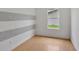 Bright bedroom featuring laminate wood floors and gray striped wall at 1053 E Hancock Dr, Deltona, FL 32725