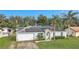 Single-story home with solar panels, attached garage, and landscaped yard at 1053 E Hancock Dr, Deltona, FL 32725