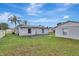 Backyard view showing house, detached garage and grassy area at 1053 E Hancock Dr, Deltona, FL 32725