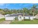 House with solar panels and a green lawn at 1053 E Hancock Dr, Deltona, FL 32725