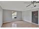 Spare bedroom with tile floors, ceiling fan, and access to backyard at 1053 E Hancock Dr, Deltona, FL 32725