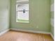 Light green walls and laminate floors in this cozy bedroom at 1053 E Hancock Dr, Deltona, FL 32725