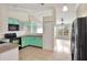 Updated kitchen with teal cabinets and a view of the dining area at 1053 E Hancock Dr, Deltona, FL 32725