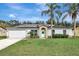 House exterior featuring a garage and landscaping at 1053 E Hancock Dr, Deltona, FL 32725
