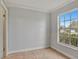 Simple bedroom with tile floors and a window overlooking the yard at 1053 E Hancock Dr, Deltona, FL 32725