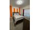Bedroom with orange accent wall and double bed at 1144 Challenge Dr, Davenport, FL 33896