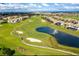 Aerial view of community golf course with pond and fountain at 1144 Challenge Dr, Davenport, FL 33896