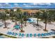 Relaxing pool area with lounge chairs and palm trees at 1144 Challenge Dr, Davenport, FL 33896