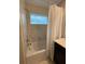 Bathroom with a bathtub and marble-tiled walls at 1144 Challenge Dr, Davenport, FL 33896