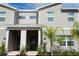 Modern two-story townhome with palm trees at 1144 Challenge Dr, Davenport, FL 33896