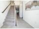 Modern staircase with wood railing and carpeted steps at 1812 Tropical Palms Cir, Kissimmee, FL 34747