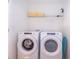 Bright laundry room with washer, dryer, and shelving at 1812 Tropical Palms Cir, Kissimmee, FL 34747