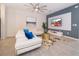 Modern living room with white sectional sofa and large TV at 1812 Tropical Palms Cir, Kissimmee, FL 34747