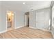 Spacious bedroom with wood-look floors and access to a bathroom at 2094 Derwent Dr, Davenport, FL 33896