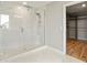 Elegant bathroom with a large glass shower, marble tile, and walk-in closet at 2094 Derwent Dr, Davenport, FL 33896
