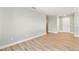Spacious bedroom with wood-look floors and access to a hallway at 2094 Derwent Dr, Davenport, FL 33896
