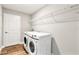 Laundry room with washer, dryer, and overhead shelving at 2094 Derwent Dr, Davenport, FL 33896