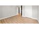 Spacious bedroom with wood floors and an open door to hallway at 2094 Derwent Dr, Davenport, FL 33896