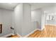Upstairs hallway with light gray walls and wood flooring at 2094 Derwent Dr, Davenport, FL 33896