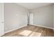 Simple bedroom with hardwood floors and access to hallway at 2094 Derwent Dr, Davenport, FL 33896