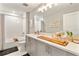 Elegant bathroom with double vanity and white tile at 2094 Derwent Dr, Davenport, FL 33896