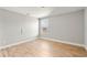 Bright bedroom featuring wood flooring and a large window at 2094 Derwent Dr, Davenport, FL 33896