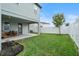 Spacious backyard with a grassy lawn and covered patio at 2094 Derwent Dr, Davenport, FL 33896
