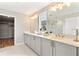 Elegant bathroom with double vanity and a large mirror at 2094 Derwent Dr, Davenport, FL 33896