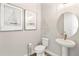 Powder room with pedestal sink and decorative accents at 2094 Derwent Dr, Davenport, FL 33896