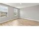 Bright bedroom with wood-look floors and large windows offering natural light at 2094 Derwent Dr, Davenport, FL 33896