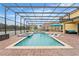 Inviting pool area with covered patio, spa, and lounge chairs at 2760 Rialto Ct, Kissimmee, FL 34746