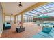 Covered patio with pool and lounge area at 2760 Rialto Ct, Kissimmee, FL 34746