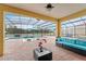 Covered patio with pool and lounge area at 2760 Rialto Ct, Kissimmee, FL 34746