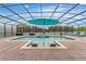 Screened pool area with lounge chairs and umbrella at 2760 Rialto Ct, Kissimmee, FL 34746