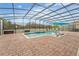 Screened pool area with lounge chairs and umbrella at 2760 Rialto Ct, Kissimmee, FL 34746