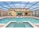 Large pool and spa with covered patio and lounge chairs at 2760 Rialto Ct, Kissimmee, FL 34746