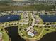 Aerial view showing community pool, lake, and homes at 3133 Queen Alexandria Dr, Kissimmee, FL 34744