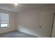 Bright bedroom with gray carpet, window blinds, and an ensuite bathroom at 3245 Sustainable Way, Kissimmee, FL 34747