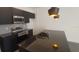 Modern kitchen with stainless steel appliances and dark cabinetry at 3245 Sustainable Way, Kissimmee, FL 34747