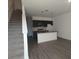 Modern kitchen with island and stairs visible at 3245 Sustainable Way, Kissimmee, FL 34747