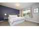 King size bed, nightstands with lamps, and a large window at 4410 Le Reve Ct, Kissimmee, FL 34746