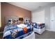 Two twin beds with themed bedding and a double door closet at 4410 Le Reve Ct, Kissimmee, FL 34746