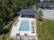 Aerial view of community pool with lounge chairs and a covered cabana at 4410 Le Reve Ct, Kissimmee, FL 34746