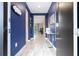 Bright entryway with blue walls, wood-look floors, and a view to the living area at 4410 Le Reve Ct, Kissimmee, FL 34746