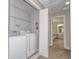 Convenient laundry room with washer, dryer, and shelving at 4410 Le Reve Ct, Kissimmee, FL 34746