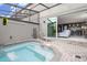 Relaxing spa with waterfall feature, and view into the home's interior at 4410 Le Reve Ct, Kissimmee, FL 34746