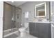 Clean bathroom with a glass shower door and gray vanity at 4410 Le Reve Ct, Kissimmee, FL 34746