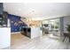 Open kitchen with island, stainless steel appliances, and gray cabinets at 4410 Le Reve Ct, Kissimmee, FL 34746