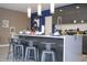 Kitchen island with seating for four and a white countertop at 4410 Le Reve Ct, Kissimmee, FL 34746